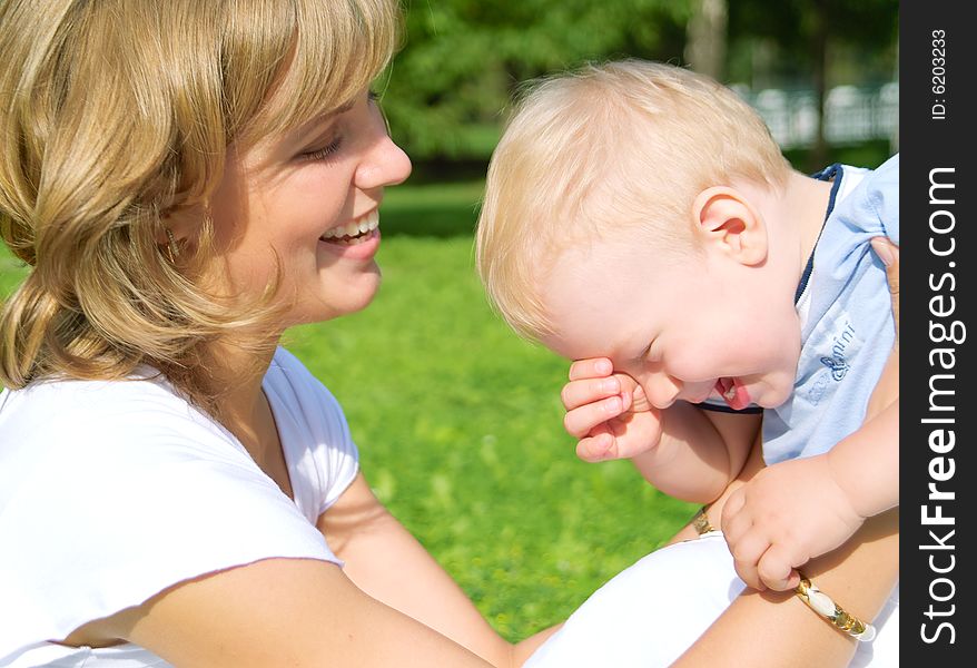 Mother and son rest in the park summer day