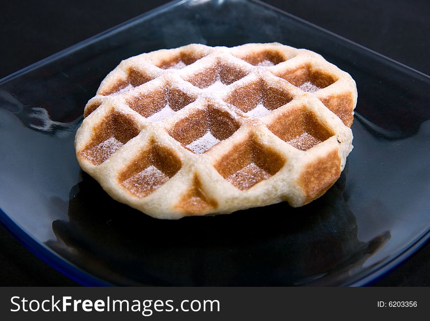 Happy Waffle on plate isolated on black background