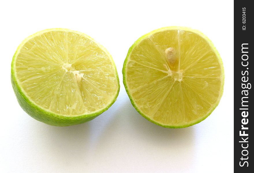 Cut in half lime isolated on white