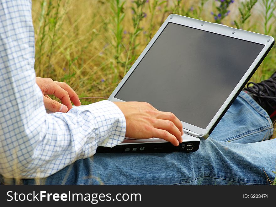 Male hands typing on a laptop