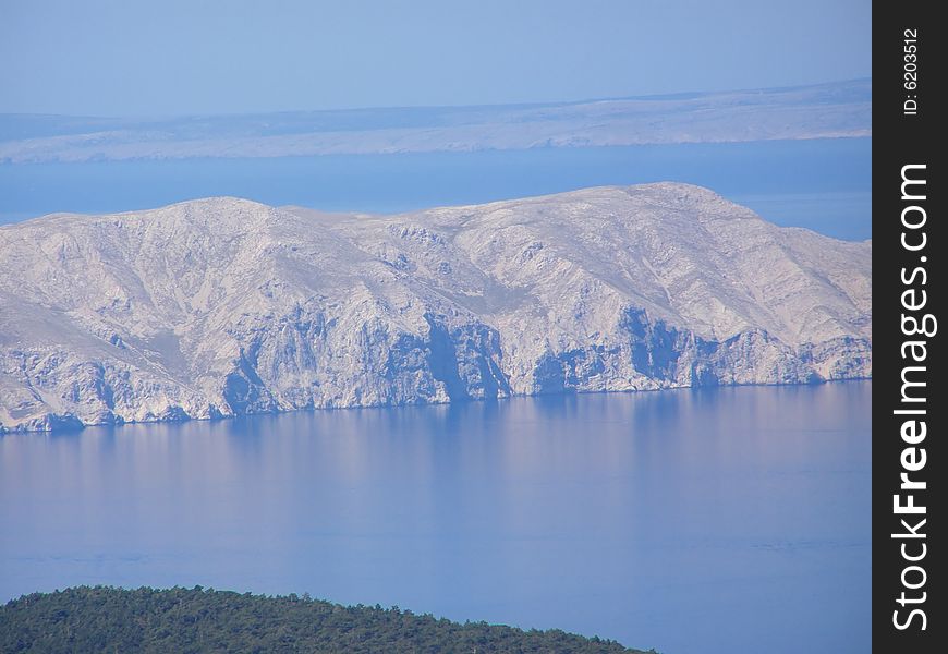 Croatia - view from the Velebit Mountain (Vratnik Pass) to the Adriatic Sea and Kvarner Bay - islands of  Krk and Cres in the background. Croatia - view from the Velebit Mountain (Vratnik Pass) to the Adriatic Sea and Kvarner Bay - islands of  Krk and Cres in the background