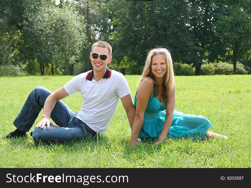 Happy young couple relaxing in park