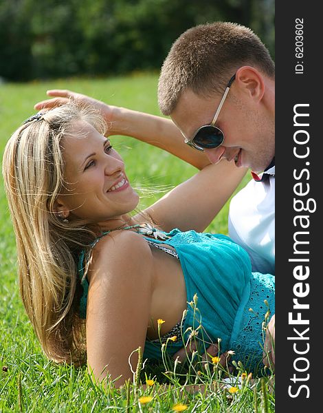 Happy young couple relaxing in park. Happy young couple relaxing in park