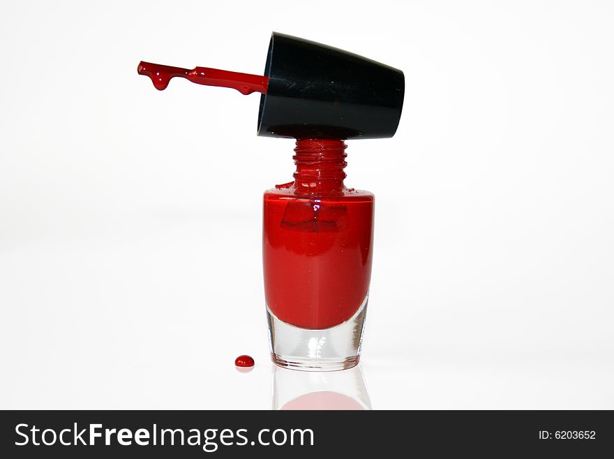 Red nail polish which stand on a white background. Red nail polish which stand on a white background