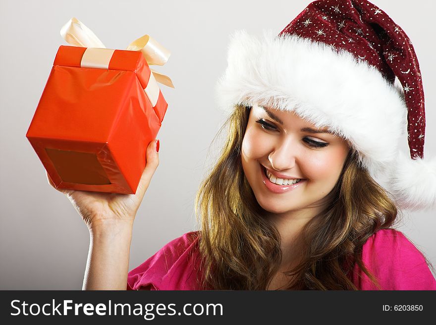 Winter portrait of a beautiful young smiling woman with a christmas cap. Winter portrait of a beautiful young smiling woman with a christmas cap