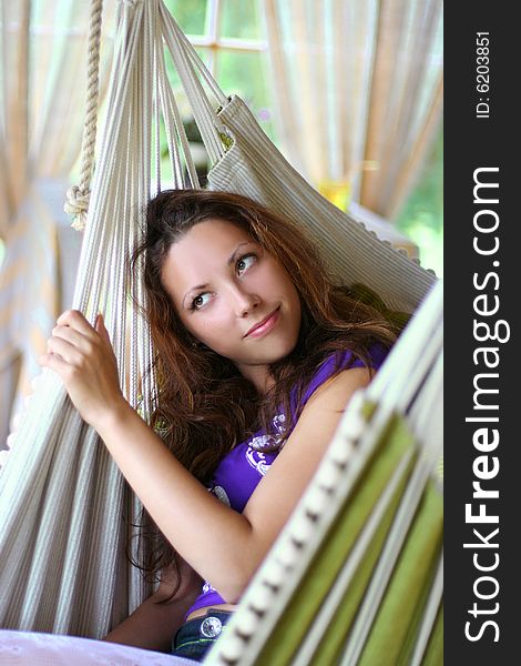 Beautyful long-haired girl relaxing in hammock. Beautyful long-haired girl relaxing in hammock