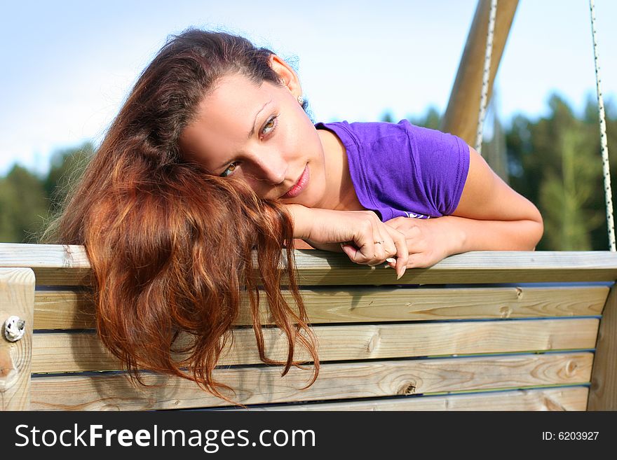 Beautyful long-haired girl relaxing in park