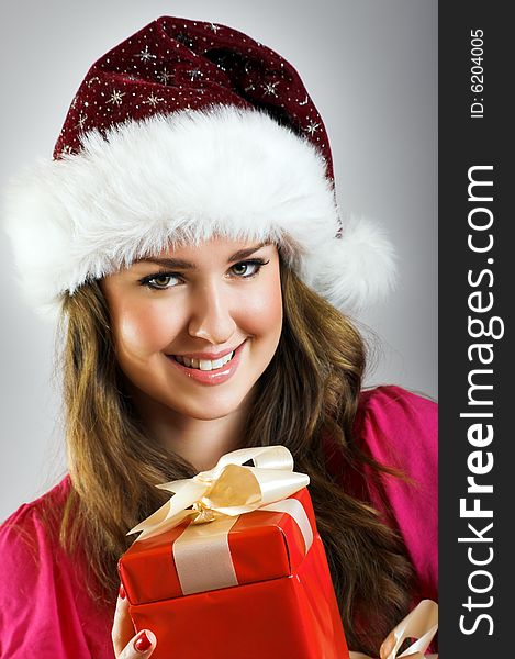 Winter portrait of a beautiful young smiling woman with a christmas cap. Winter portrait of a beautiful young smiling woman with a christmas cap