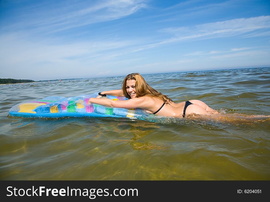 Beautiful Girl Swimming On Mattress