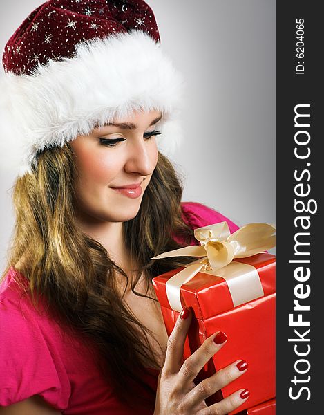 Winter portrait of a beautiful young smiling woman with a christmas cap. Winter portrait of a beautiful young smiling woman with a christmas cap