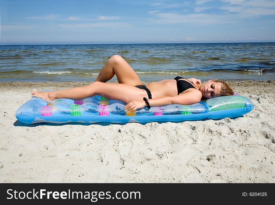 The fine girl on a beach at the sea