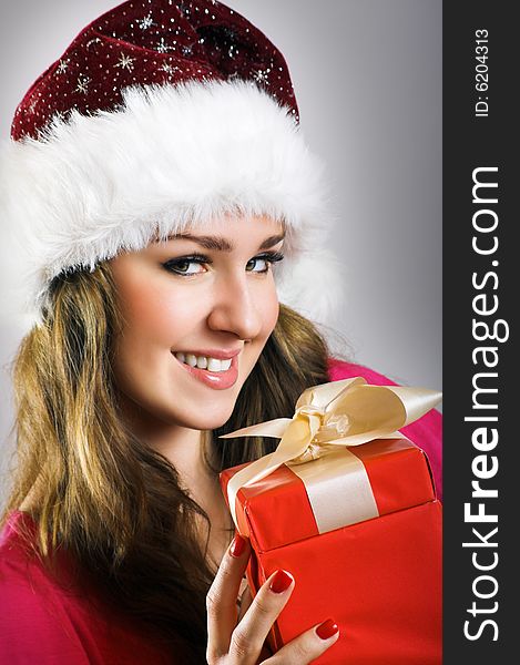 Winter portrait of a beautiful young smiling woman with a christmas cap. Winter portrait of a beautiful young smiling woman with a christmas cap