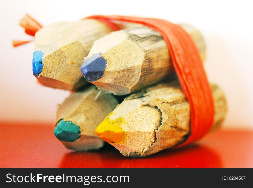 Four colored pencils tied together