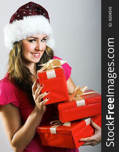 Winter portrait of a beautiful young smiling woman with a christmas cap. Winter portrait of a beautiful young smiling woman with a christmas cap