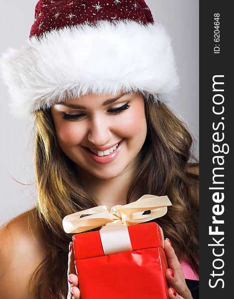 Winter portrait of a beautiful young smiling woman with a christmas cap. Winter portrait of a beautiful young smiling woman with a christmas cap