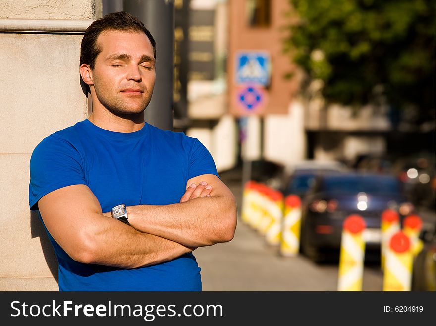 Caucasian resting man standing on the streets. Caucasian resting man standing on the streets