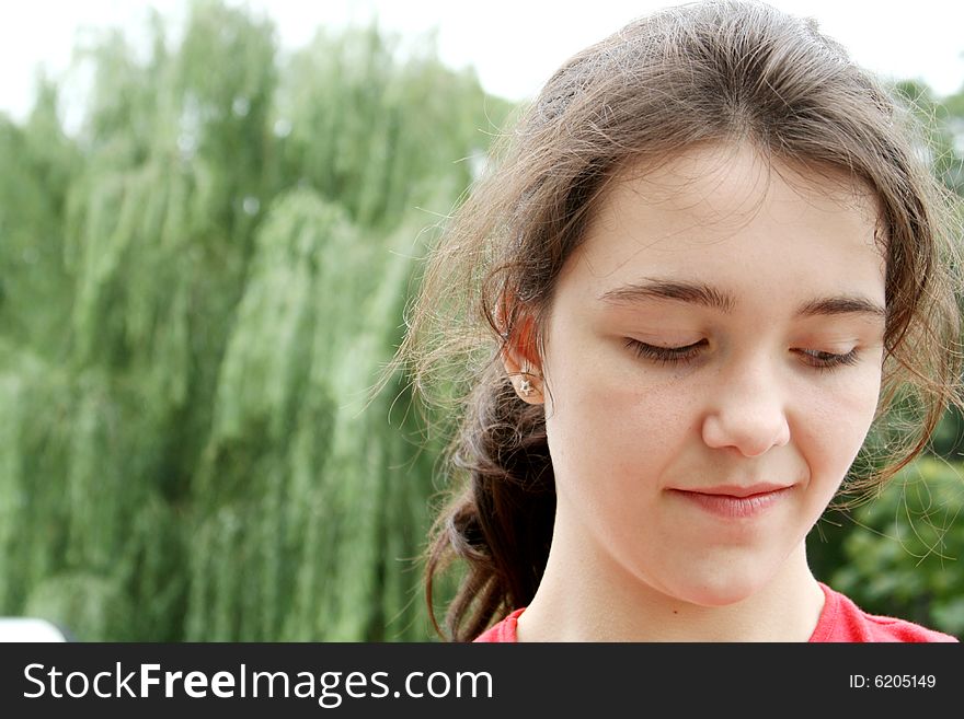 Young brunette teen girl lookin down. Young brunette teen girl lookin down