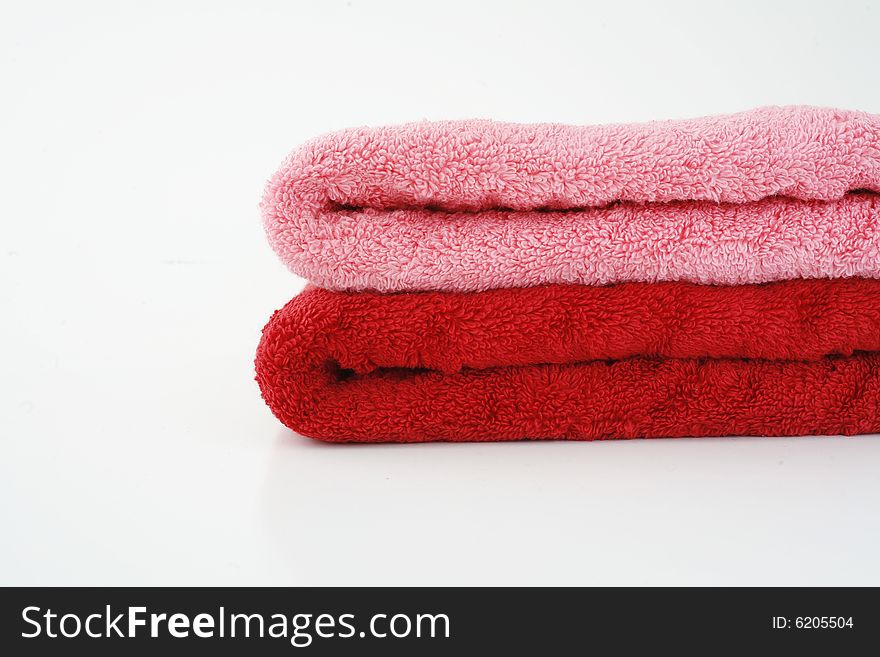 Pink and red towels on neutral background