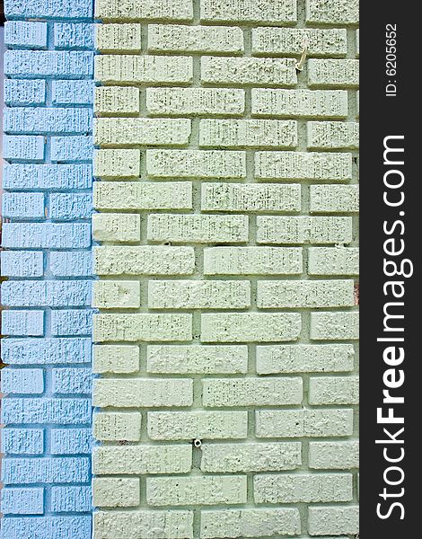 An old brick wall painted blue and green. An old brick wall painted blue and green