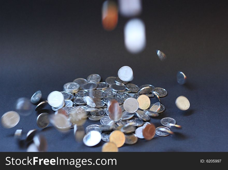 Strewed coins on a black background
