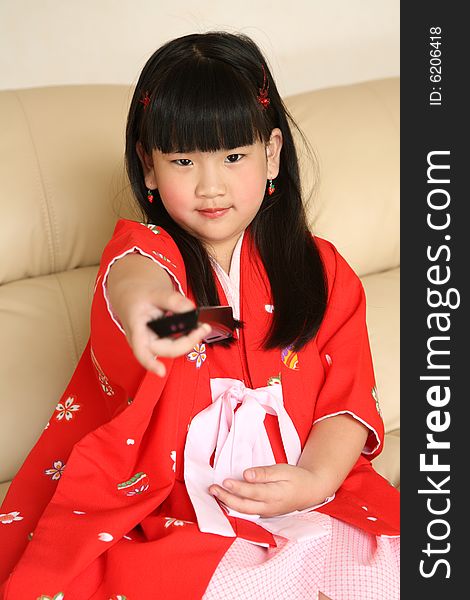 cute little Chinese girl watching TV. cute little Chinese girl watching TV
