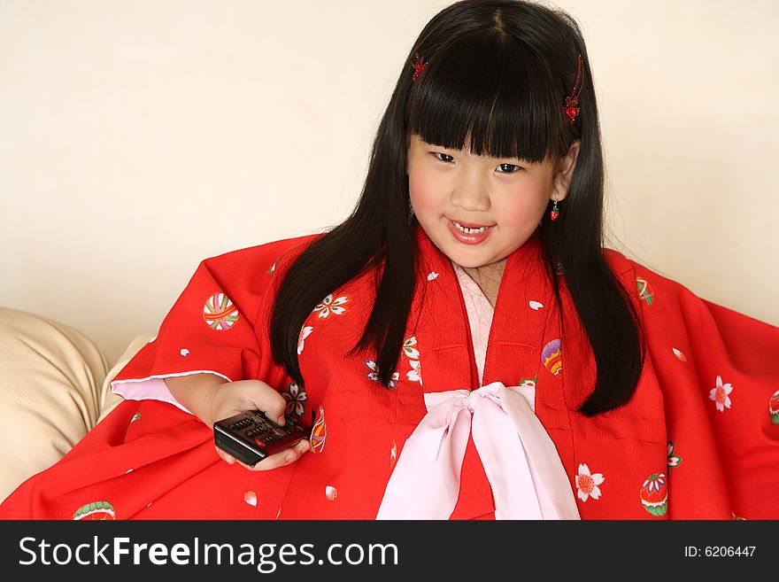 Cute little Chinese girl watching TV. Cute little Chinese girl watching TV