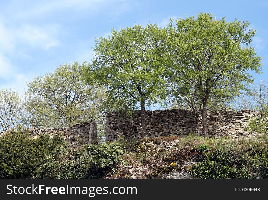 Part of the Saint-Hippolyte medieval ruins, in the town of Cremieu, France. Wall of the old fortifications. Part of the Saint-Hippolyte medieval ruins, in the town of Cremieu, France. Wall of the old fortifications.