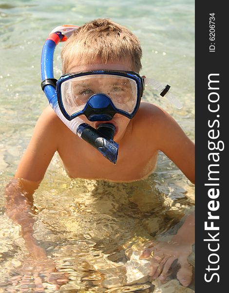 Boy on a beach ready to swim. Boy on a beach ready to swim