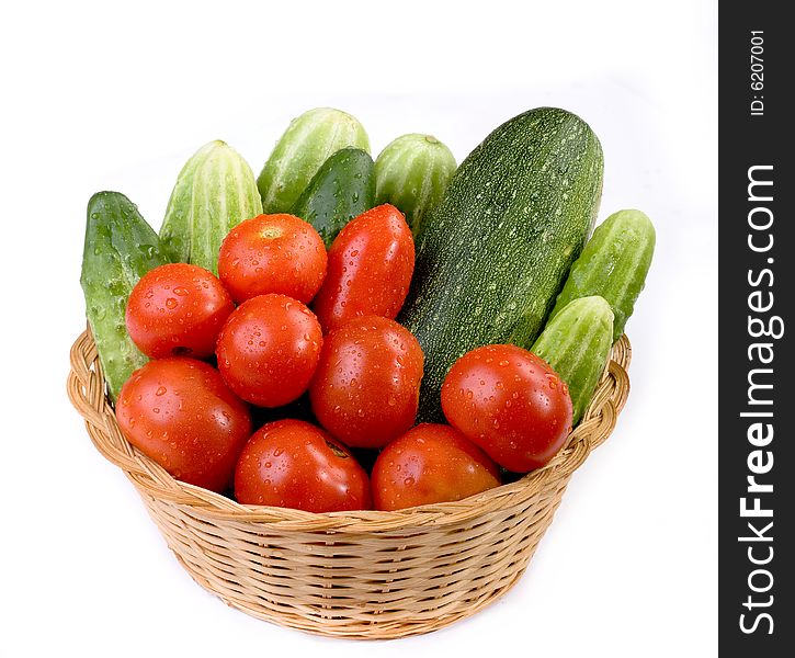 Vegetables in the basket isolated on a white background