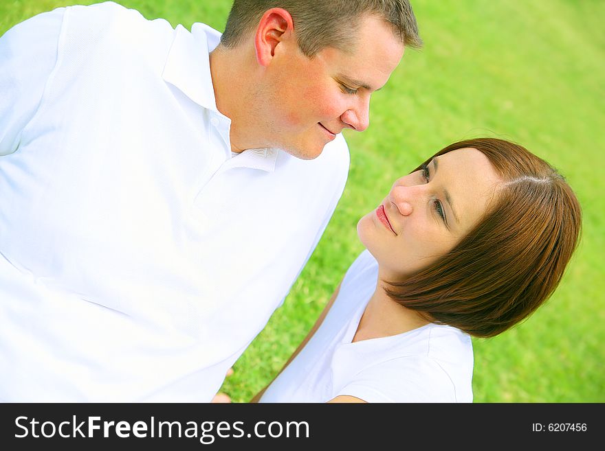 Happy couple embracing and playing in the park. concept for family and young people. Happy couple embracing and playing in the park. concept for family and young people