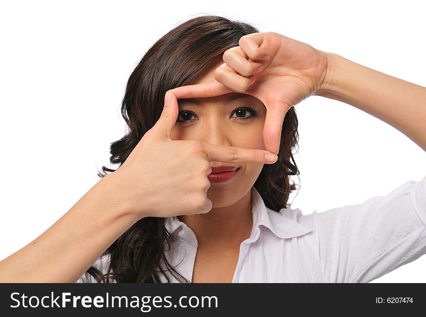 A pretty young asian woman with framing hands isolated on white