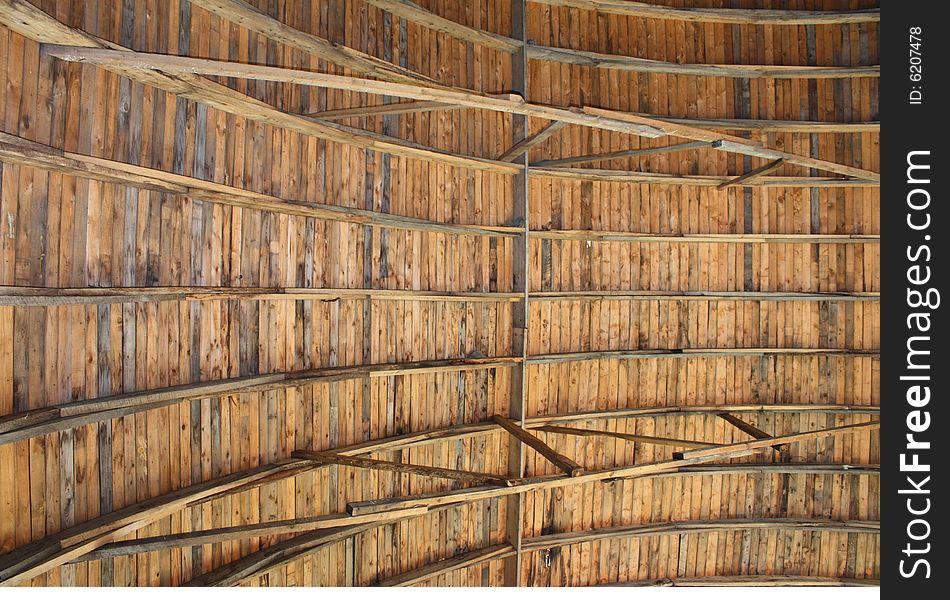 A wooden ceiling of an old barn. A wooden ceiling of an old barn.