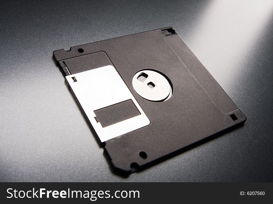 Floppy disk lays on a gray background. Floppy disk lays on a gray background
