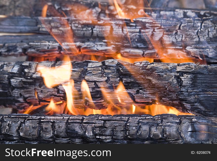 Scorched wood in flame (background). Scorched wood in flame (background)