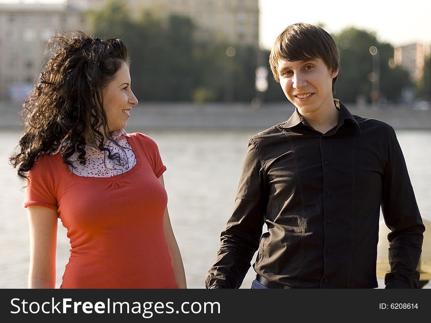 Outdoor portrait of young happy attractive couple together