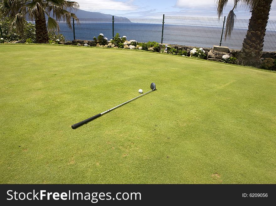 Detail of golfball and iron on golfcourse