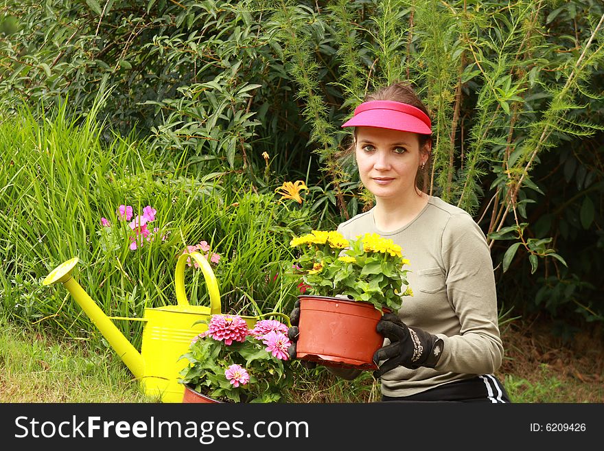 Young beautiful women working in the garden. Young beautiful women working in the garden