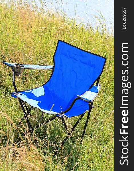 The blue outdoor chaire on river bank