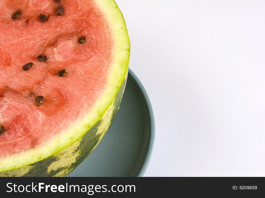 Appetizing slices of watermelon in a blue plate. Isolated on white background.