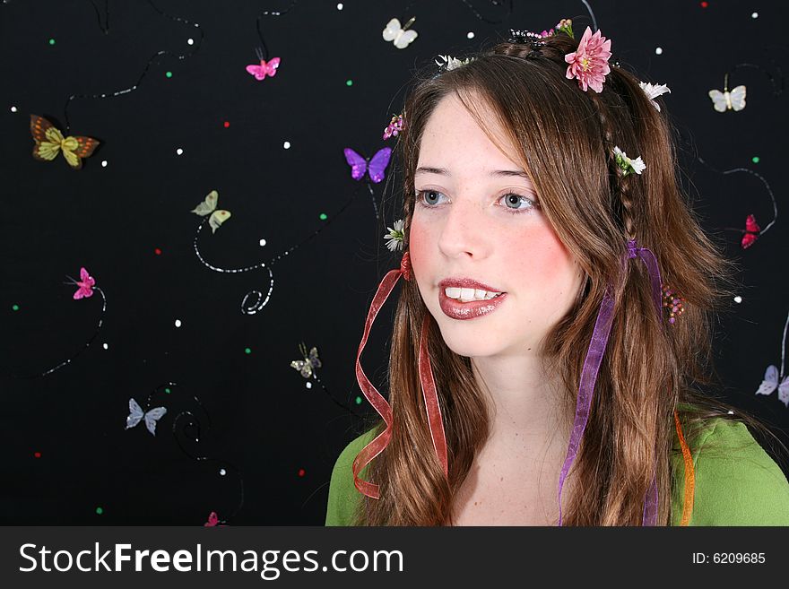 Teenage model with flowers and butterflies in her hair. Teenage model with flowers and butterflies in her hair