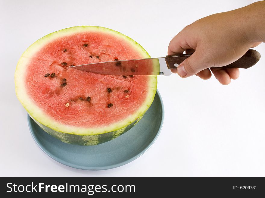 Appetizing slices of watermelon in a blue plate. Isolated on white background.