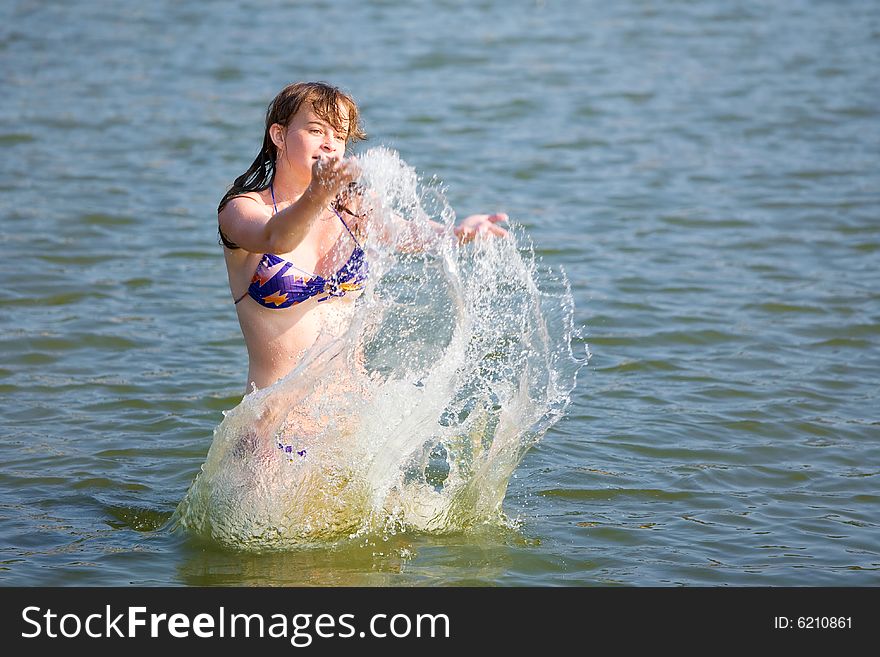 The girl has fun in the summer on water. The girl has fun in the summer on water