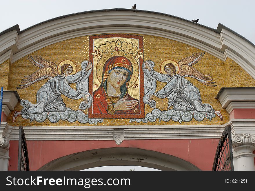 Brick gate of a monastery with an icon and two angels. Brick gate of a monastery with an icon and two angels