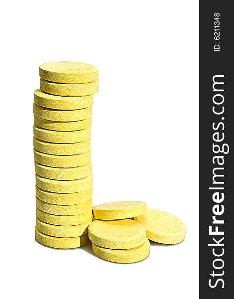 Stack of yellow tablets on the white background