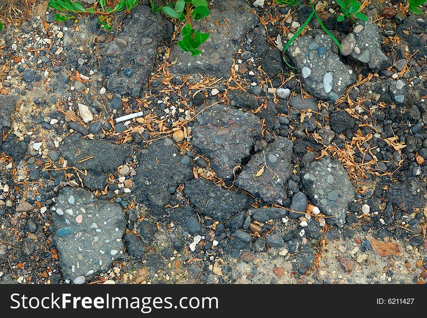 Close-up of destroyed asphalt pavement