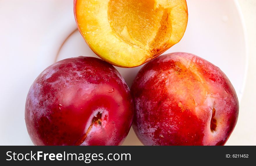 Closeup of three ripe plums