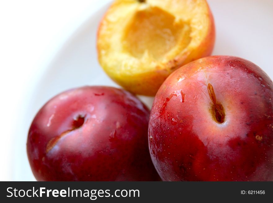 Closeup of three ripe plums