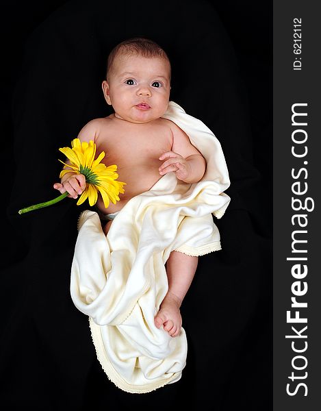 A little cute baby portrait with yellow flower. A little cute baby portrait with yellow flower