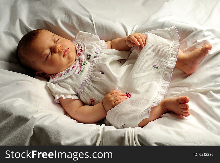 A little cute baby portrait over white sleeping. A little cute baby portrait over white sleeping