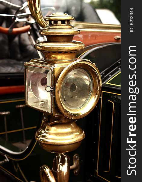 Brass lamp on vintage American steam car.